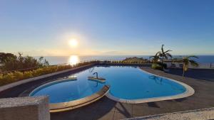a swimming pool with the ocean in the background at Villa Sofia *Luxury experience in Calabria in Zambrone