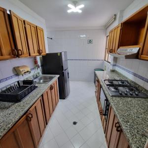 a kitchen with a sink and a refrigerator at apartamento-rodadero-laureles-1601 by reservastodo in Santa Marta