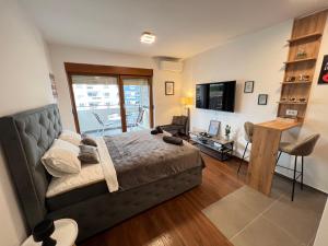 a bedroom with a bed and a living room at White Homes 16 - Master Quart in Podgorica