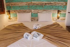 a bedroom with a bed with towels on it at Pousada ON VIBE Cumbuco in Cumbuco