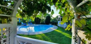 a swimming pool in a yard with a white fence at Villa Maud in Middleburg