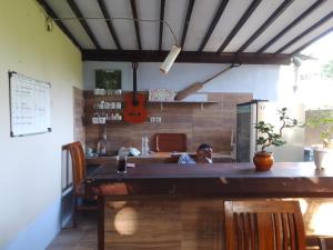 a man sitting at a counter in a kitchen at Mangga homestay Gili air in Gili Air