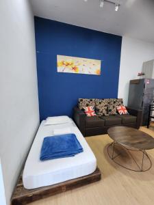 コタキナバルにあるBC The Loft 2A Imago Studioのベッド、ソファ、テーブルが備わる客室です。