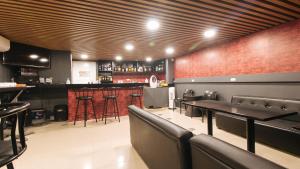 a restaurant with tables and chairs and a bar at RedDoorz Plus at La Belle Residences Makati City in Manila