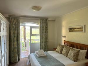 a bedroom with a bed and a large window at Caribbean Estates 29 Montego Bay in Port Edward +12 photos
