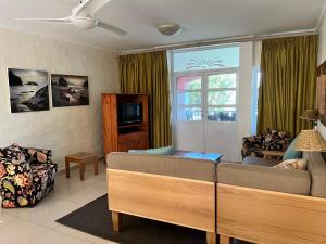 a living room with a couch and a tv at Caribbean Estates 29 Montego Bay in Port Edward