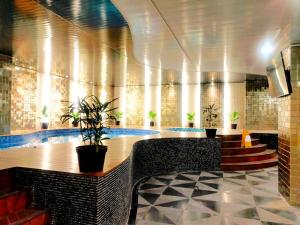 a lobby with a swimming pool in a building at Grand Orchardz Hotel Kemayoran Jakarta in Jakarta