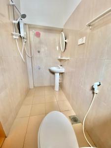 a bathroom with a toilet and a sink at Yal's Town Inn in Jaffna