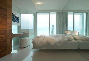 Letto o letti in una camera di i-Suite Hotel