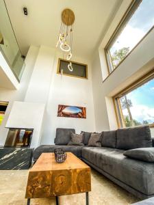 a living room with a couch and a table at Ferienvilla Joachimsberg mit Swimspa und Sauna in Wienerbruck