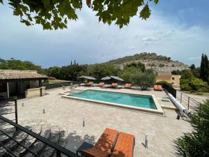 a swimming pool with chairs and a house at Domaine de Calypso & Suites - Adult Only in Auriol