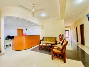 a living room with a couch and a piano at Yal's Town Inn in Jaffna