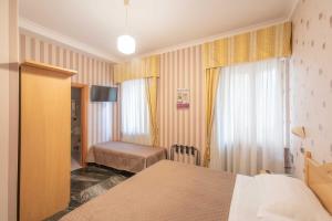 Säng eller sängar i ett rum på Hotel Siviglia