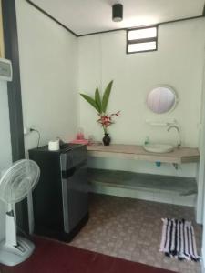 a bathroom with a sink and a toilet in a room at Lok Mun Bungalows in Ko Yao Noi