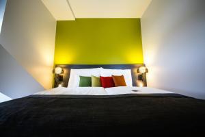 a bedroom with a large bed with colorful pillows at Clarion Hotel Energy in Stavanger