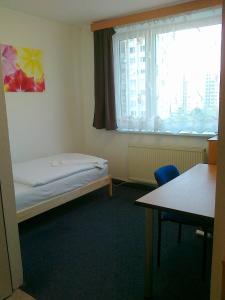 a small room with a bed and a window at Terrace Room Rental in Bratislava