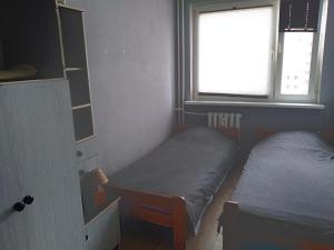 a bedroom with two beds and a window at krynicka in Wrocław