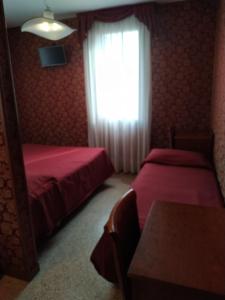 A bed or beds in a room at Atlantide Hotel