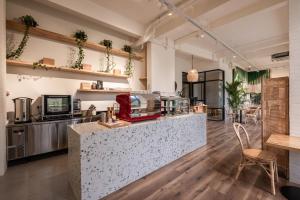 a restaurant kitchen with a counter and a table at La Boheme, Rooms and Coffee in Jakarta