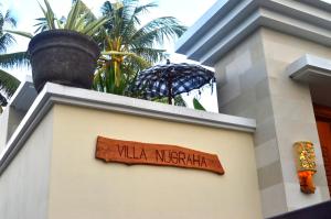 a sign on the side of a building at Villa Nugraha Lovina Private Pool in Singaraja