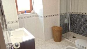 a bathroom with a shower and a sink and a toilet at Casa Florinda Casa con terraza in Lariño +19 photos