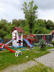 a playground with slides and a play house at Casa Tican in Bran