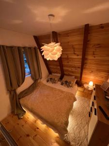 a bedroom with a bed and a chandelier at WoodMood in Žabljak +43 photos