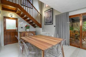 a dining room with a wooden table and chairs at San Lameer Villa 3212 - 4 Bedroom Superior - 8 pax - San Lameer Rental Agency in Southbroom