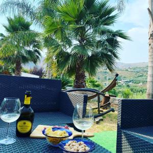 a table with two glasses and a bottle of wine at Villa Assia in Gaeta