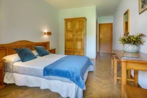 Postel nebo postele na pokoji v ubytování Hotel Lo Foraton