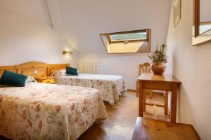 Ein Bett oder Betten in einem Zimmer der Unterkunft Hotel Lo Foraton