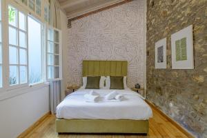 a bedroom with a bed with two towels on it at Incomparable Plaka's Luxury Apt Private Pool in Athens +22 photos