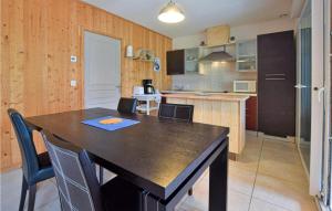 a kitchen with a table and chairs in a room at Nice Home In Crances With Wifi in Créances