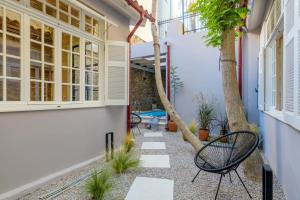 a courtyard with two benches and a tree at Incomparable Plaka's Luxury Apt Private Pool in Athens