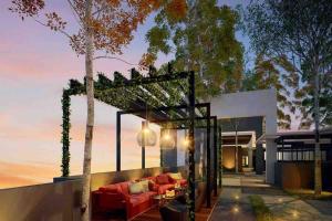 an outdoor living room with a red couch at Emira Shah Alam 2 BED ROOM in Shah Alam