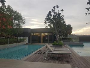 a house with a swimming pool in front of a building at Emira Shah Alam 2 BED ROOM in Shah Alam +8 photos