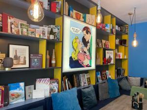 a room with bookshelves and shelves filled with books at Pop Аrt Bungalows in Primorsko