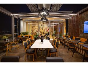 a dining room with a table and chairs at La Terrazza Hotel in Famagusta