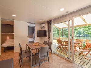 a living room and dining room with a table and chairs at Cottage on the edge of the fishing pond in Laurière +14 photos