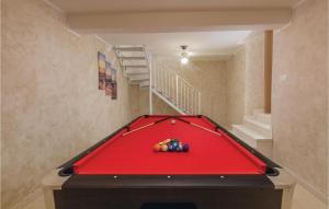 a red pool table in a room with a staircase at 4 Bedroom Gorgeous Home In Pican in Pićan