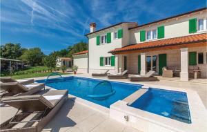 a villa with a swimming pool and a house at 4 Bedroom Gorgeous Home In Pican in Pićan