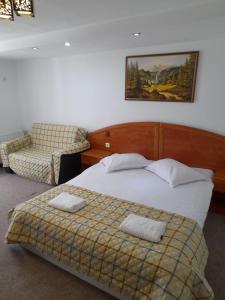 a bedroom with a bed with two towels on it at Casa Tican in Bran