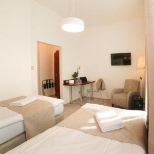 Postel nebo postele na pokoji v ubytování Hotel KOZÁK