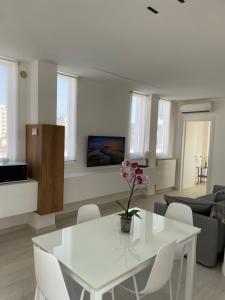 a white table and chairs in a living room at BREZZA DI MARE - attico vista mare con terrazza in Termoli