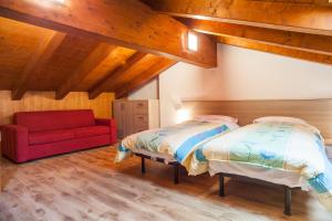 Postel nebo postele na pokoji v ubytování Albergo Diffuso Dolomiti