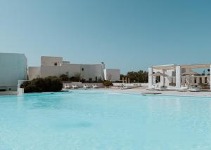 a large swimming pool in a hotel room at Archipelagos Resort in Agia Irini Paros