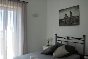 a bedroom with a bed and a picture on the wall at Bed & Breakfast Zia Menga - Luogosanto Sardinia in Luogosanto