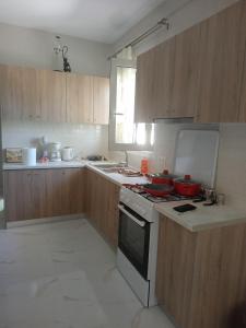 a kitchen with wooden cabinets and a stove top oven at Village House in Ágios Matthaíos +21 photos