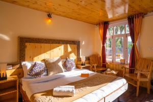 a bedroom with a large bed in a room at Rainbow Hostelier in Leh +201 photos