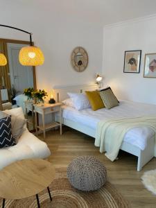 a bedroom with two beds and a couch at Cozy Little Place in Sighetu Marmaţiei
